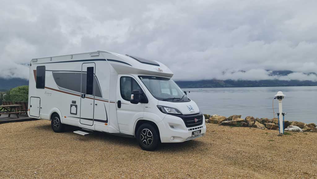 Writing content marketing overlooking the sea in a rental motorhome