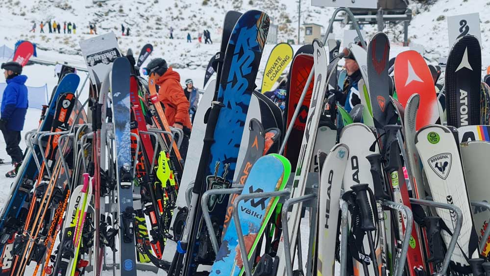 Full racks of rental skis and snowboards on the mountain