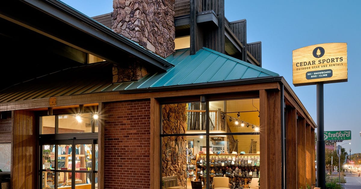 The Cedar Sports ski and snowboard rental store exterior at dusk, Utah